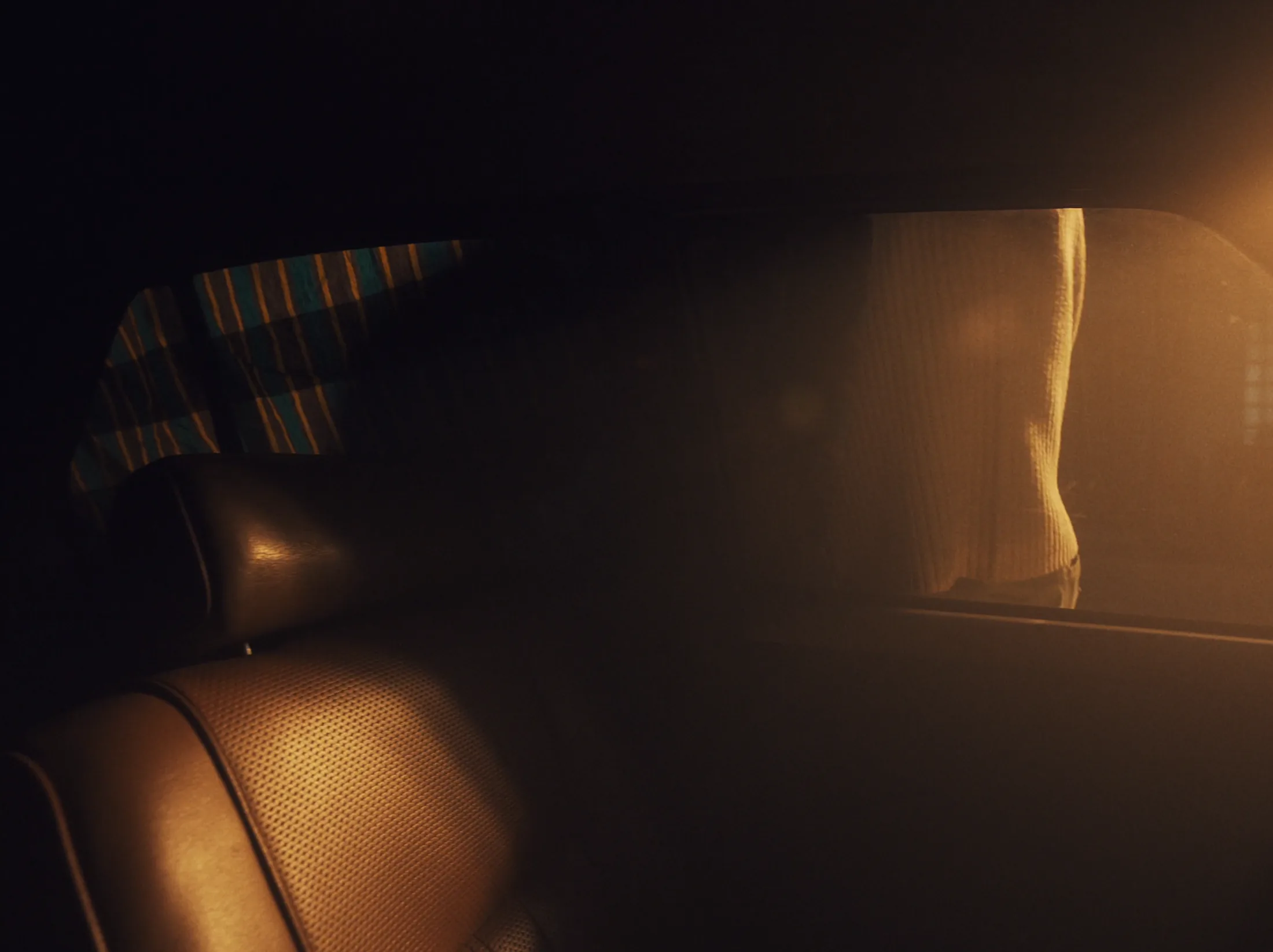 Back seat of a car with golden light through the window
